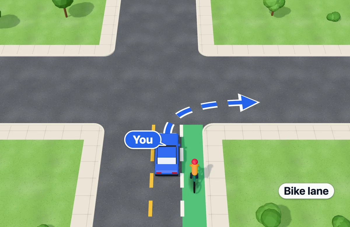 Car about to turn right across a bike lane, with a cyclist in the lane